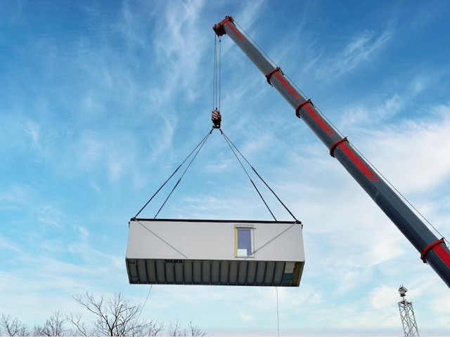 Crane rigging sets construction trailers at NJ hospital renovation site