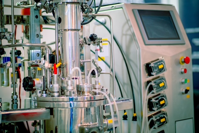 R. Baker & Son riggers installing 24 pharmaceutical bioreactors with platforms and safety railings in upstate New York facility