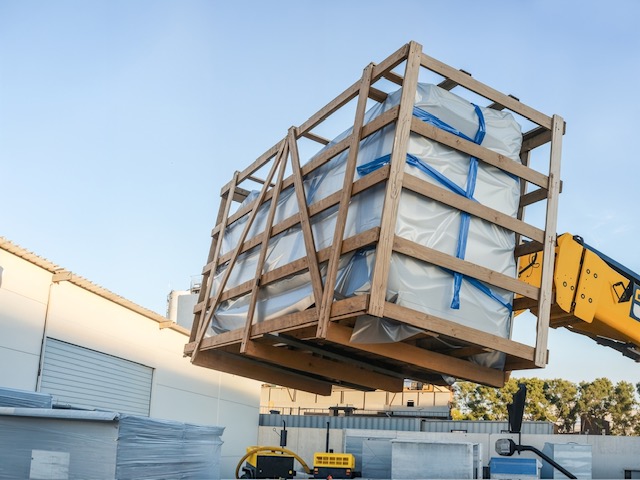 Nine downflow booths carefully dismantled and packaged for refurbishment during pharmaceutical lab renovation.