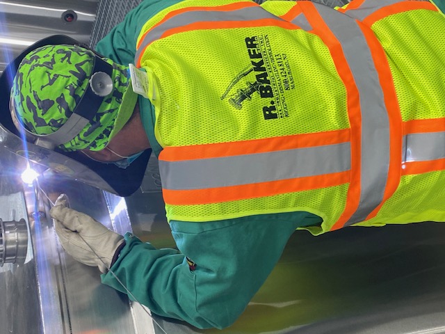 Rigger working on R. Baker & Son - All Industrial Services. Welding.