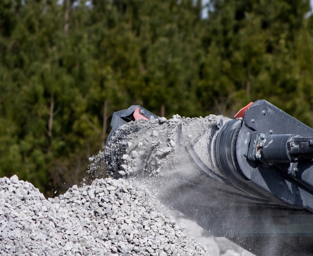Demolition concrete debris fed into an industrial crusher for recycling